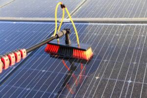 Technician cleaning rooftop solar panels at Adelaide home in Australia